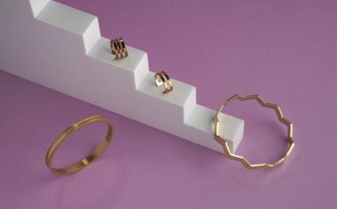 Modern design golden bracelets and rings on stairs podium on purple background