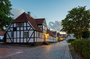 street view of a big half-timbered house in black and white in the evening dusk, Mariager, August 6, 2022