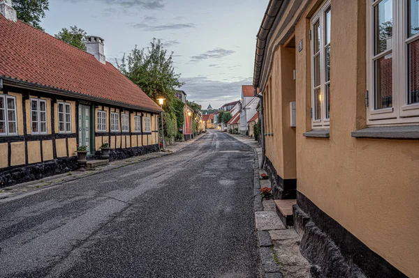 street in the small danish town Mariager at sunset, leading up to the church, Mariager, Denmark, August 7, 2022