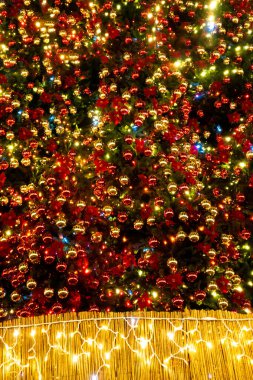 Festive background of round Christmas tree decorations and garlands.