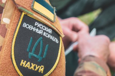 Chevron on the shoulder of a Ukrainian soldier with the inscription Russian warship go fuck yourself.