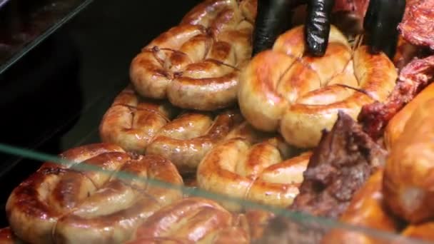 Close-up of workers hand puts the grilled sausage on display — Stock Video