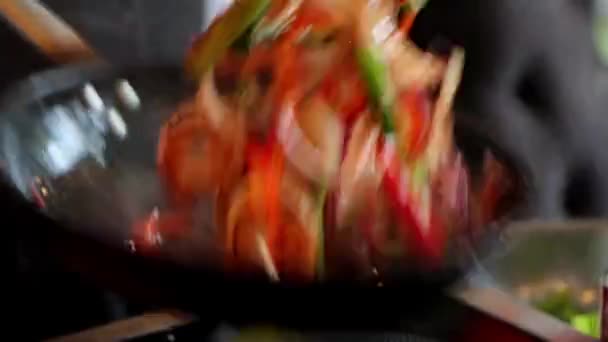 Close-up of chef is tossing ingredients in frying pan — Stock Video