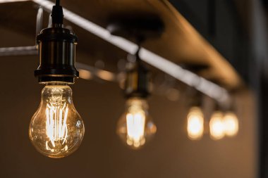 Retro light bulbs hanging in department store, with decorate interior luxury, fixtures combine beautiful modernity Designer, lamps on the ceiling