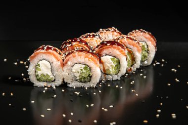 Set of Different Sushi and Rolls over Black Background