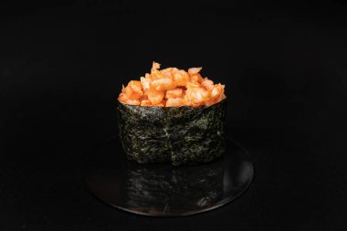 Set of Different Sushi and Rolls over Black Background