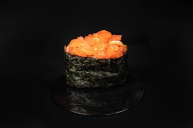 Set of Different Sushi and Rolls over Black Background