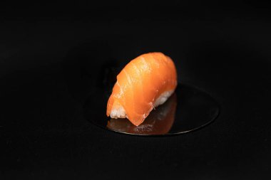 Set of Different Sushi and Rolls over Black Background