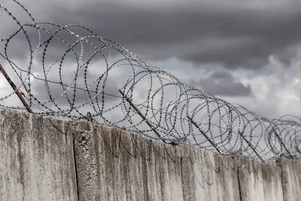 Barbed wire. Barbed wire on fence with blue sky to feel worrying.