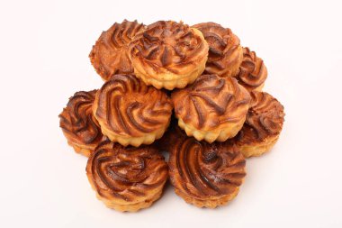 Overhead shot of classic New York cheesecake with fresh blueberries on top sliced on wooden stand at the white background with copy space