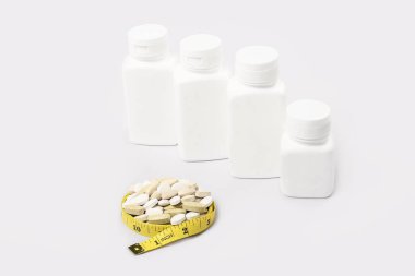 Vtamin D and Omega 3 fish oil capsules supplement on white background.