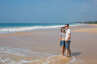Portrait of lovely couple in love having fun on the beach. Young beautiful people hugging . Romantic moment. Valentine's day. Honey moon.