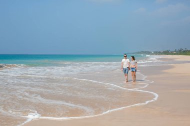 Portrait of lovely couple in love having fun on the beach. Young beautiful people hugging . Romantic moment. Valentine's day. Honey moon.