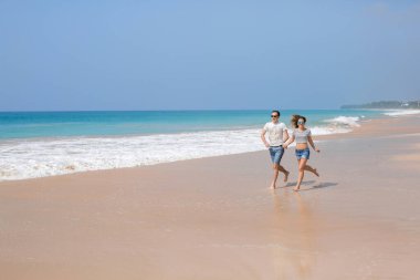 Portrait of lovely couple in love having fun on the beach. Young beautiful people hugging . Romantic moment. Valentine's day. Honey moon.
