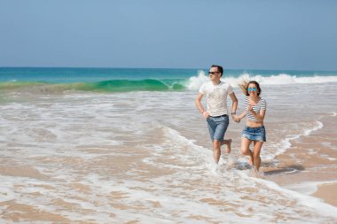 Portrait of lovely couple in love having fun on the beach. Young beautiful people hugging . Romantic moment. Valentine's day. Honey moon.