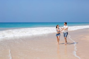 Portrait of lovely couple in love having fun on the beach. Young beautiful people hugging . Romantic moment. Valentine's day. Honey moon.