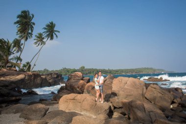 Portrait of lovely couple in love having fun on the beach. Young beautiful people hugging . Romantic moment. Valentine's day. Honey moon.