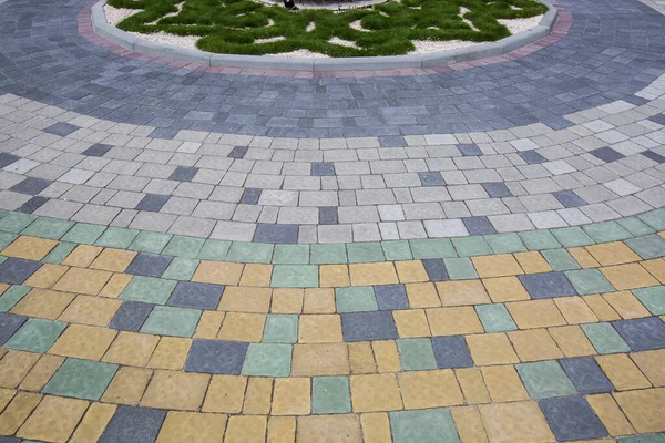 Stone pavement with grass texture. Top view on cobblestoned pavement background. Abstract background of old cobblestone pavement street