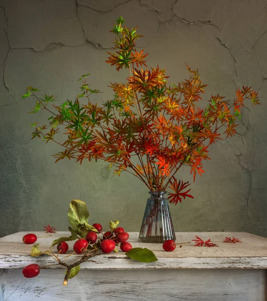 Bir buket orman menekşesi Sonbahar yaprakları ve kırmızı böğürtlenlerle.