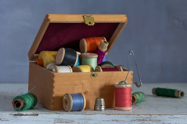 Still life with sewing accessories and a box. Vintage.