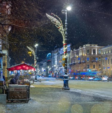 St. Petersburg, Russia - 26 DEC 2021 Winter night Nevsky Prospekt and falling snow