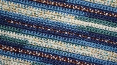 Blue striped crochet pattern background, slow clockwise rotation