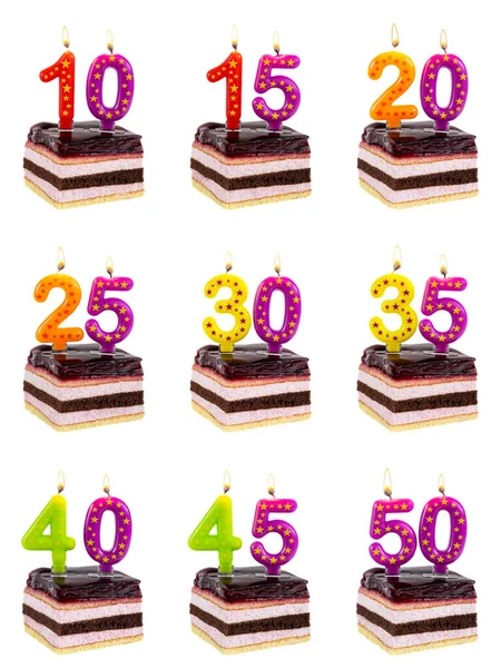 Set of cherry birthday cakes with burning candles in the form of numbers - 10, 15, 20, 25, 30, 35, 40, 45, 50, anniversary concept