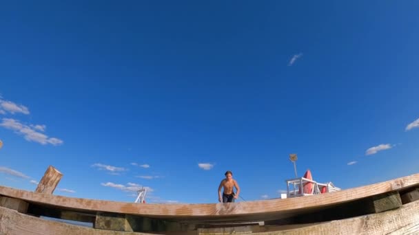 Boy Runs Jumps Water Lake River Sea Wooden Pier Slow — стоковое видео