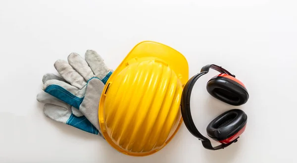 Safety equipment helmet gloves and ear muffs. Work wear protection isolated on white background, Personal protective gear, top view