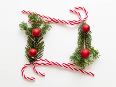 Noel boş çerçevesi, baston şekerler ve beyaz arka planda izole edilmiş Xmas ağacı dalı. Taze köknar ve dekorasyon sınırı, boşluk. Tatil tebrik kartı tasarımı, şablon