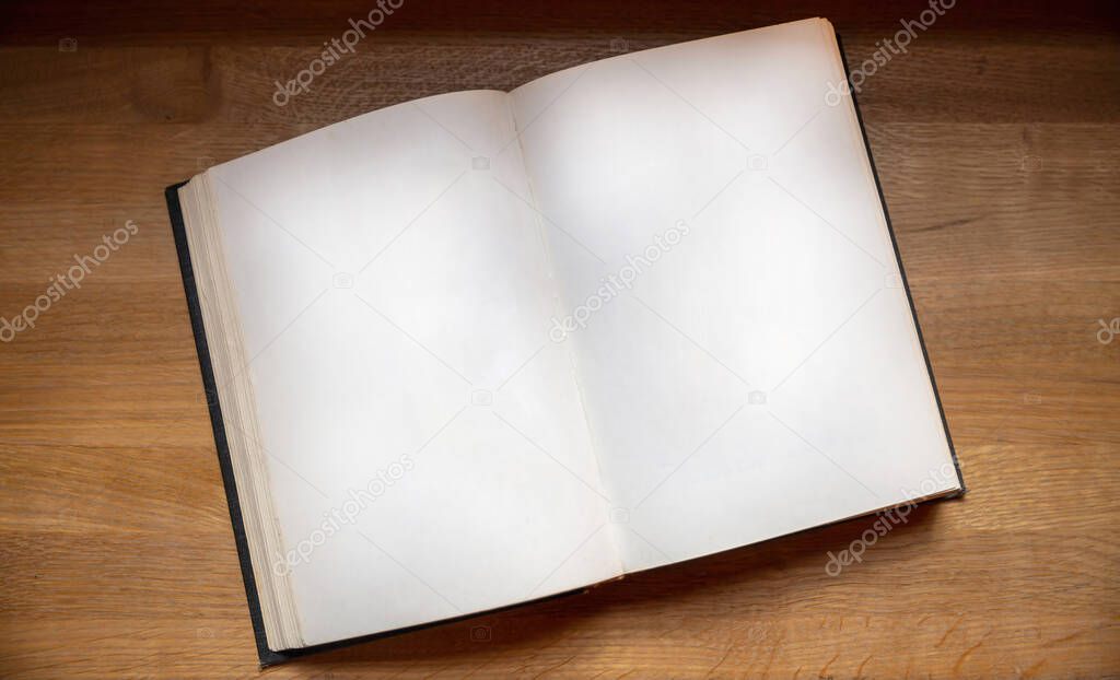 Open notebook on wooden background, top view. Blank book page on a table. Copy space, note templat
