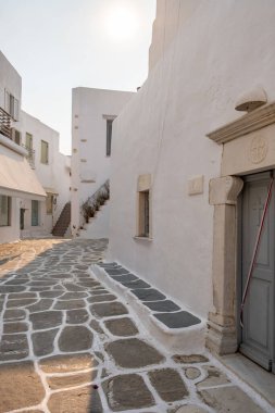 Paros island, Greece. Whitewashed building, empty narrow cobblestone street and stair at Naousa old town
