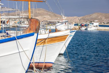 Fishing boat anchored at Naousa old harbor, Paros island Greece, Cyclades. Traditional wooden vessel for tourist transportation, closeup. Summer holiday