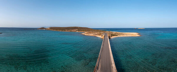 Greece. Aerial panoramic view over Kythira Diakofti bridge going to island harbor, blue sky and sea, sunny summer day
