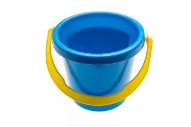 Bucket toy isolated on white. Blue plastic container with yellow handle, baby and kid activity with sand at the beach