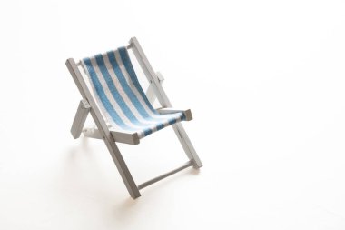 Deck chair, white blue striped beach chair isolated on white background. Summer vacation, sea resort design element