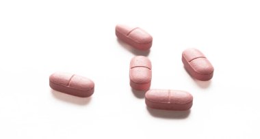 İlaç hapı beyaz arka planda izole edilmiş. Pembe haplar reçeteli, sağlık eczanesi konsepti