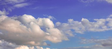 Mavi gökyüzü arka planında yağmur bulutu. Pofuduk kümülüs bulutları beyaz ve gri tonda. Hava durumu, meteoroloji konsepti