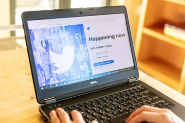 Greece, Athens, January 23 2022. TWITTER LOGIN. Tweet App, social networking. Online login at account. PC on table, person hand on keyboard,