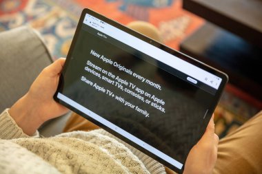 Greece, Athens, January 23 2022. APPLE TV. App, online movie streaming subscription service for entertainment. Digital tablet at person hand, close up view