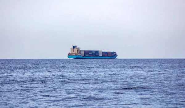 Container Cargo Ship Loaded Cruising Blue Rippled Sea Blue Cloudy — Photo