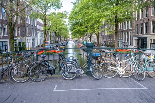 Amszterdami Csatorna Parkoló Kerékpárok Egy Hídon Csatorna Felett Virágcserepek Kikötött — Stock Fotó
