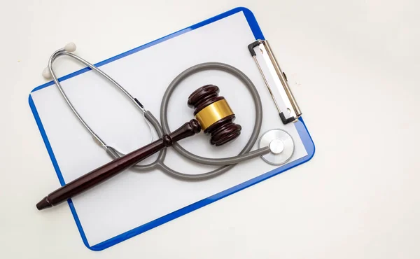 Healthcare and Law concept, Medical malpractice, personal injury lawyer. Judge gavel and doctor clipboard isolated on white, top view