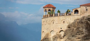 Meteora Yunanistan. Varlaam Kutsal Manastır binaları kayaların üzerinde, mavi bulutlu gökyüzü, yakın görüş. Avrupa dini seyahat hedefi