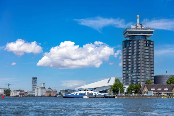 Eye Filmmuseum Amsterdam, modern skyscraper, film archive and cinema, Holland Netherlands. Waterfront high rise building, cloudy blue sky background.