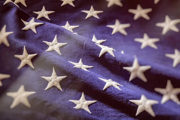 USA Flag stars close up, US of America white star on blue color textile. National American holiday celebration background.