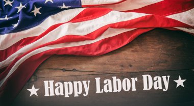 Happy Labor Day. USA Flag and text on wood. American sign on wooden table. US holiday celebration 