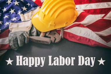 Happy Labor Day text, USA flag and construction tools. United States America holiday celebration