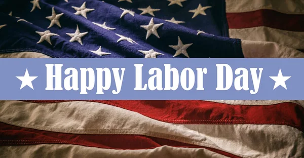 Happy Labor Day text on USA Flag background, close up view. National US America holiday celebration
