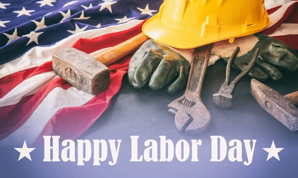 Happy Labor Day text, USA flag and construction tools. United States America holiday celebration